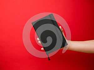 Hand of European men holding black note. Isolated on background. Studio portrait