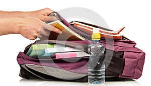 Hand with exercise book and bag