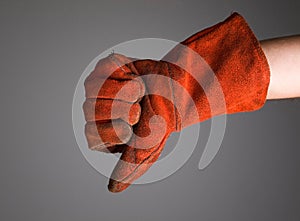 Hand expressing negativity with welder glove