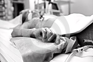 Hand extremely exhausted patients dying in a hospital bed. Black