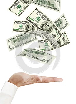 Hand and falling money isolated on white