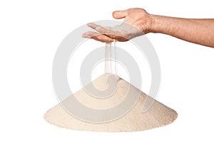 Hand with falling sand on pile
