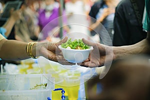 Hand-feeding to the needy in society : Concept of Feeding : Volunteers give food to the poor : donating food is helping human