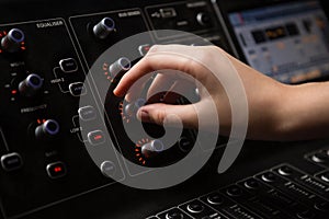 Hand of female audio engineer using sound mixer