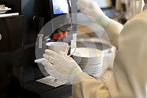 Hand of a female hotel staff at Automatic coffee service in the hotel for customer service