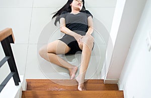 Hand female touching her leg injured,Asian woman falling down of staircase