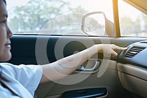 Hand of female turning on car air conditioning system,Button on dashboard in car panel