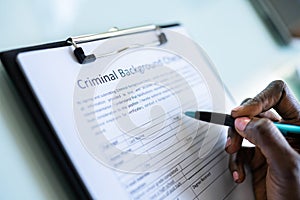 Hand Filling Criminal Background Check Form