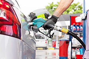 Man filling diesel fuel in car at gas station photo