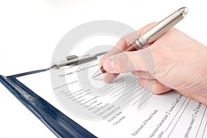Hand filling in medical questionnaire form