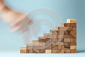 Hand finger walk on stacked wooden block like stairs.