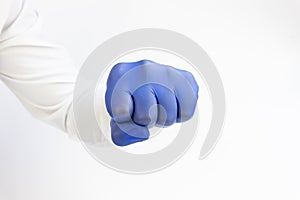 Hand , fist in blue latex Glove ready to punch. White background