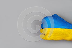 Hand fist painted in the Ukrainian flag. Place for text. Ukraine vs Russia in world war crisis concept