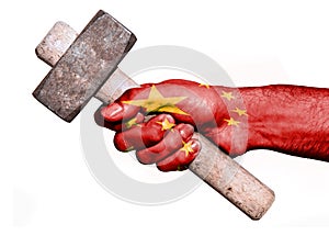 Hand with flag of China handling a heavy hammer