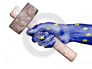 Hand with flag of European Union handling a heavy hammer