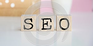 Hand flip SEA to SEO text wooden cube blocks on table background. Search Engine Optimization, Advertising, Idea, Strategy,