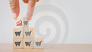 Hand flip the top wooden block, shopping cart to growing graph, business growth, increasing sale, promotion