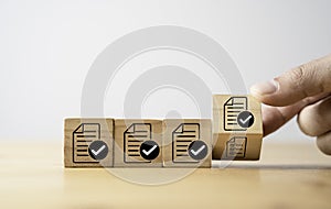 Hand Flipping correct sign with document which print screen on wooden cube block for prepare check and approve document , Quality