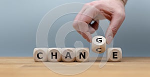 Hand flips a dice and changes the word `change` to `chance`