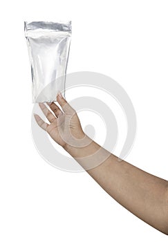 Hand with Foil package bag isolated on white