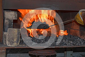 Hand forging a knife using a coal forge