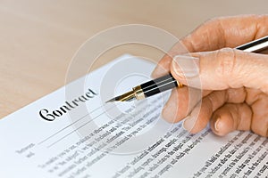 Hand with Fountain Pen Signing a Contract