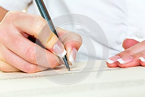 Hand with fountain pen signing contract photo