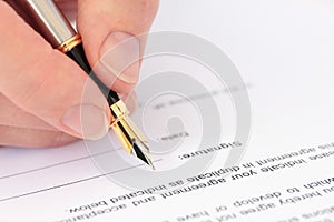 Hand with Fountain Pen Signing a Document