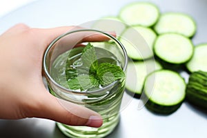 hand fresh cucumber for minty water infusion