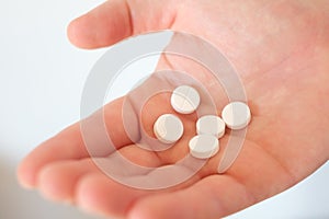 A hand full of medicines pills