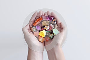 A hand full of minerals and gemstones