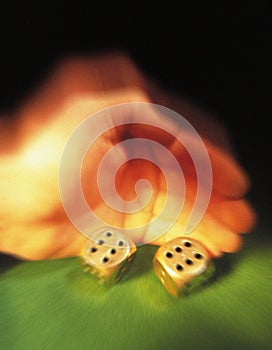 Hand of gambler rolling dice photo