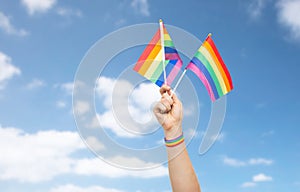 Hand with gay pride rainbow flags and wristband