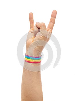 Hand with gay pride rainbow wristband shows rock