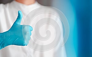 Hand gesture of doctor wearing blue gloves