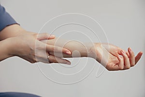 A hand gesture holding wrist with fingers and thumb