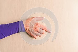 Hand gesture of middle aged woman. Mockup on desk background. Template closeup with copy space. Finger touching or scrolling.