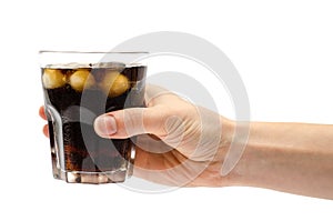 Hand of girl holding glass of rum with coke.