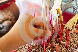 The hand of the girl holding the incense sticks to ask for blessings from sacred things