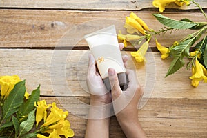 Hand of girl holding sunscreen spf50 protect for skin face