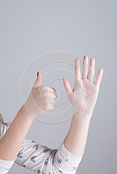 Hand of a girl showing six fingers