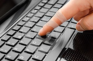 Hand of girl typing on keyboard.