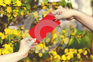 Hand give money in red envelopes - ang pow or red packet to some