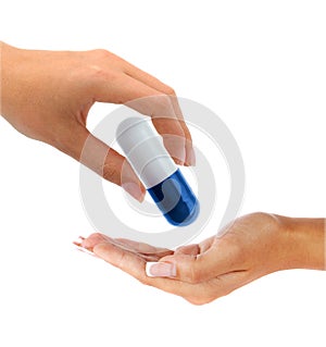 Hand gives a big pill