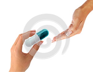 Hand gives a big pill