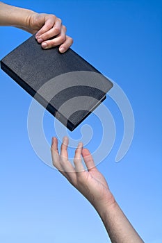 Hand Giving the Bible