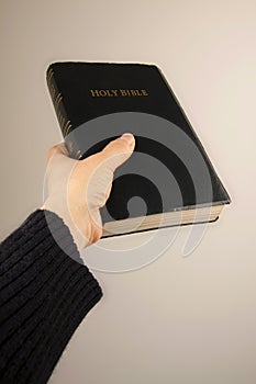 Hand giving the Bible