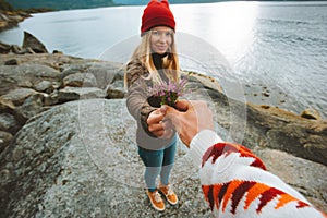 Hand giving flowers to girlfriend couple romantic dating outdoor relationship lifestyle vacations love concept