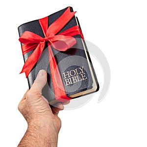 Hand giving the gift of the Holy Bible