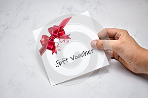 Hand Giving Gift Voucher Card. Holding Prepaid Coupon